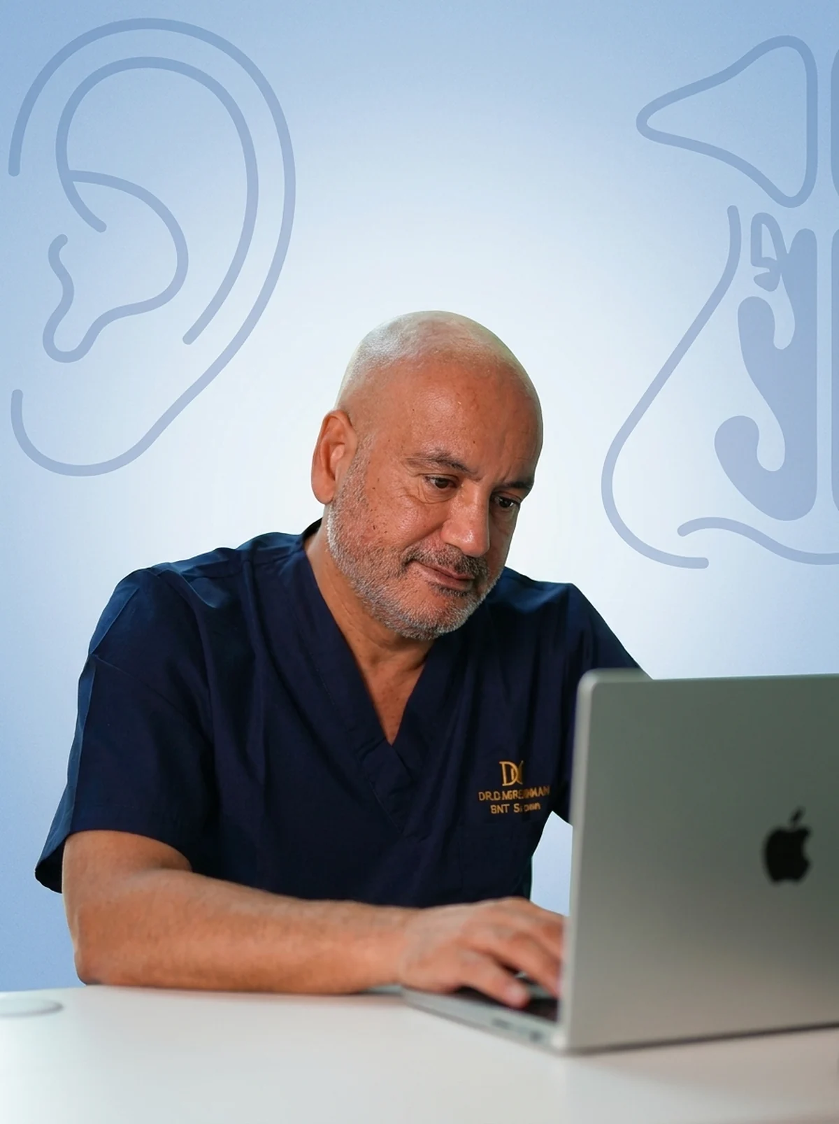 Dr. Danousch Missaghian at his desk, with line drawings of the ear and sinuses behind him
